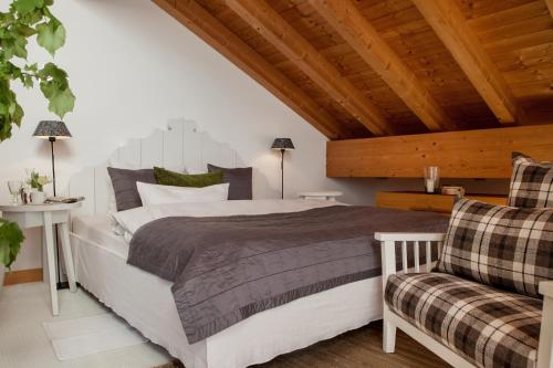 a bedroom with a large bed and a wooden ceiling at Bergesgrün in Oberstdorf