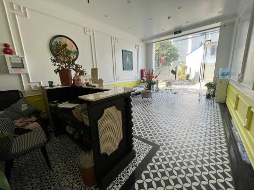 a living room with a fireplace and a large window at Song Kim Hotel in Hai Phong