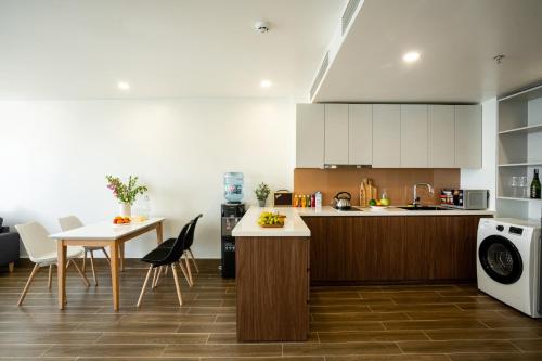 a kitchen and dining room with a table and chairs at SQ Thao Dien in Ho Chi Minh City
