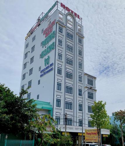 a tall white building with a crane on top at Phụng Hoàng Vũ in Bạc Liêu