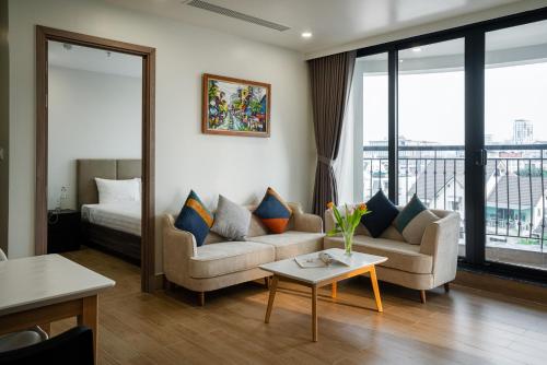 a living room with a couch and a table at SQ Thao Dien in Ho Chi Minh City