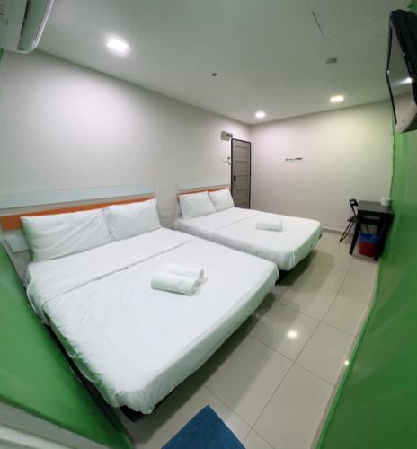 Postel nebo postele na pokoji v ubytování Red Orange Hotel Klang - 5 min to Klang Town
