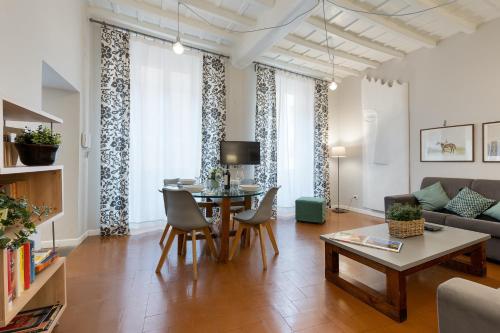a living room with a table and a couch at Rome as you feel - Grotta Pinta apartments in Rome