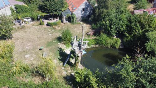 an aerial view of a pond in a yard at Vakantiewoning op Natuurterrein t Heuvelhof met optioneel hottub en sauna in Heuvelland