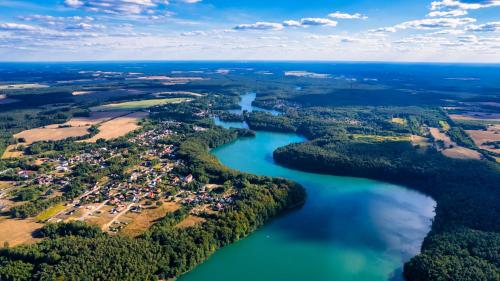 an aerial view of a river and a village at Przystań Łagówek - domki letniskowe in Łagów