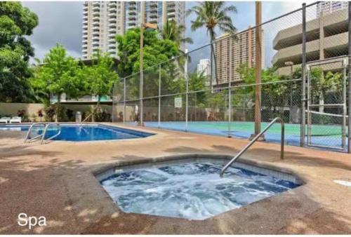 a hot tub in the middle of a swimming pool at Waikiki High-rise sea view free parking in Honolulu