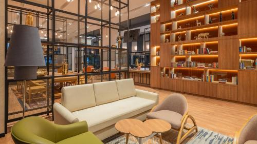 a lobby with a couch and chairs and tables at ibis Thane - An Accor Brand in Thane