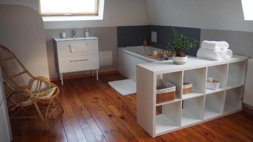 a bathroom with a white cabinet and a sink at Chez Bérénice et Clément in Miraumont