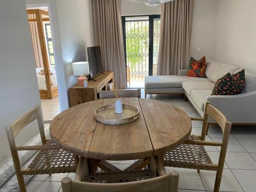 a living room with a wooden table and chairs at Villa Granito No 6, Paarl in Paarl