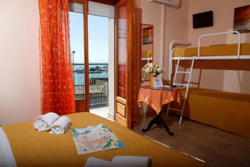 a bedroom with two bunk beds and a balcony at Zanaddina in Sciacca