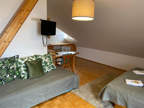 a living room with a couch and a table at Pension Rucksackpeter in Hohenbrugg an der Raab
