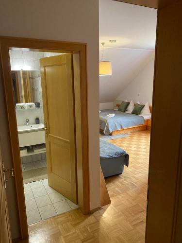 an open door to a room with a bedroom and a bed at Pension Rucksackpeter in Hohenbrugg an der Raab