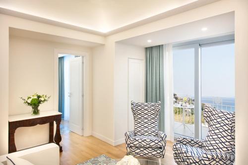 a living room with a view of the ocean at Pazziella Garden & Suites in Capri
