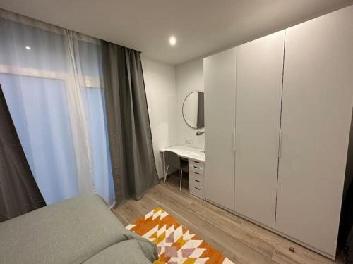 Schlafzimmer mit einem Bett, einem Schreibtisch und einem Spiegel in der Unterkunft Precioso apartamento con patio. PYP in Valencia
