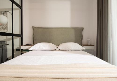 a bedroom with a bed with two pillows at CubeStudio21 in Kallithea Halkidikis