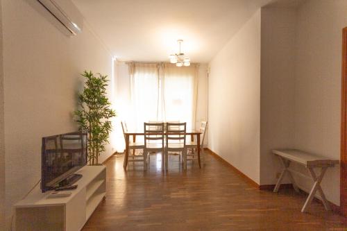 a living room with a table and a dining room at INNOUTHOME Apartamento Eixample Barcelona in Barcelona