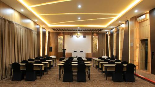 a banquet hall with tables and chairs in a room at KHAS Semarang Hotel in Semarang