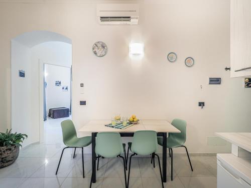 a dining room with a table and four chairs at ELI&FRA2 in La Spezia
