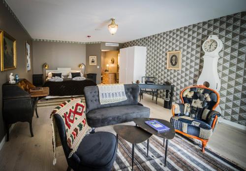a living room with a couch and a bed at Orbaden Spa & Resort in Vallsta