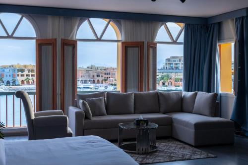 a living room with a couch and a large window at El Gouna Elite Worldwide Private Residences, Sea & Garden View - Hurghada, Egypt in Hurghada
