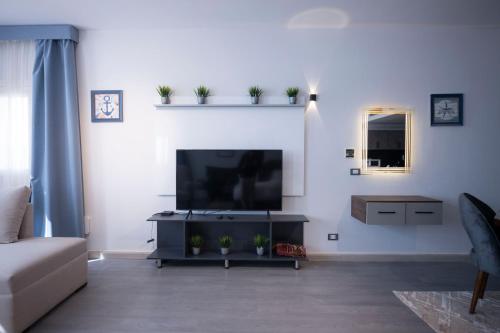a living room with a large flat screen tv at El Gouna Elite Worldwide Sea & Garden Residences - Hurghada, Egypt in Hurghada
