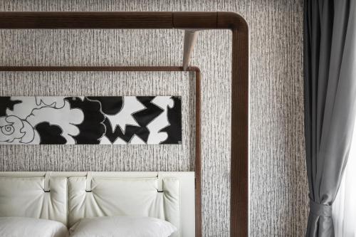 a headboard of a bed in a room at LHP Napoli Palace & SPA in Naples