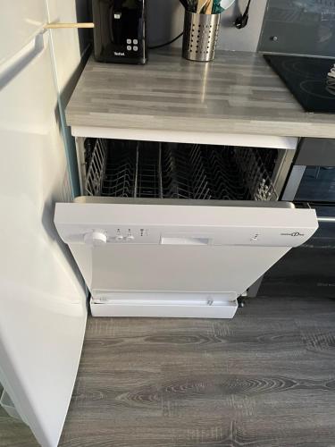 a white desk with a drawer in a kitchen at « Le temps d’un instant » dépendance in Solre-le-Château