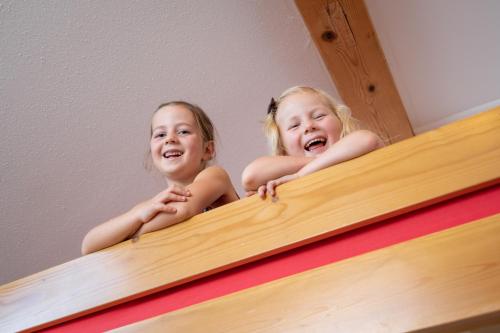 two little girls on top of a bunk bed at Ferienhof Weishäupl in Untergriesbach