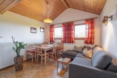 a living room with a couch and a table at Ferienhof Weishäupl in Untergriesbach