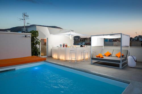 a house with a swimming pool next to a house at Giada Luxury in Terrasini