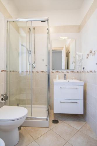 a bathroom with a shower and a toilet and a sink at Residence O'Sole Mio Pompei in Pompei