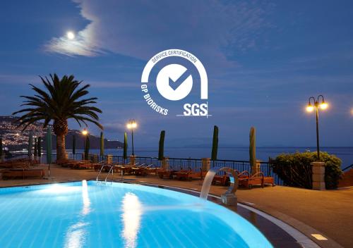 a swimming pool on the roof of a building with the sss logo at The Cliff Bay - PortoBay in Funchal