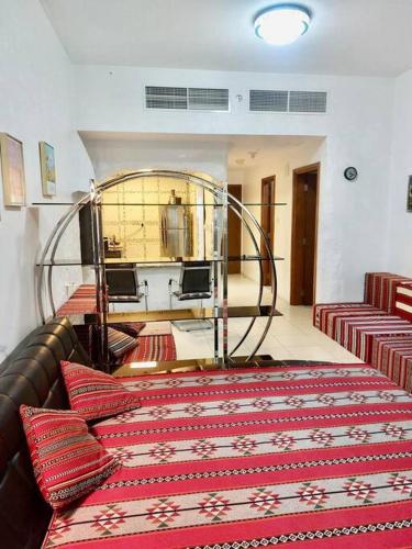 a room with a large bed with red pillows at apartment in Ajman for 4 persons near the sea in Ajman 
