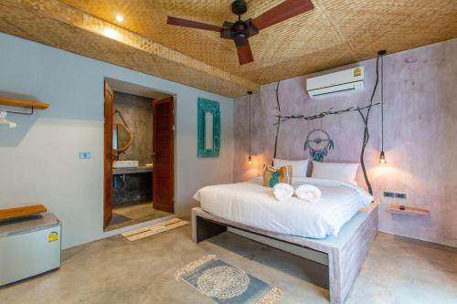a bedroom with a bed with a painting on the wall at Dreamcatcher Boutique Hotel in Bophut 
