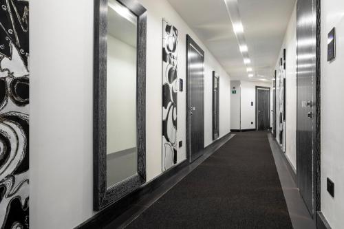 a hallway with a row of mirrors on the wall at LHP Napoli Palace & SPA in Naples