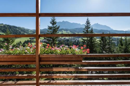 a view from the porch of a house with flowers at Hotel Melodia del Bosco in Badia