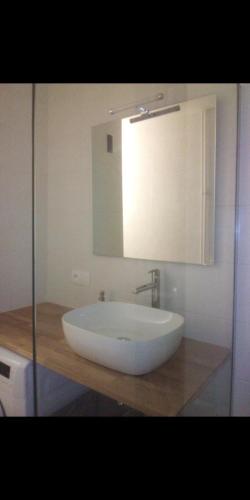 a bathroom with a large white sink and a mirror at Ambilly in Ambilly