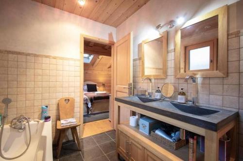 a bathroom with a sink and a tub and a toilet at Chalet Renard in Morzine in Montriond