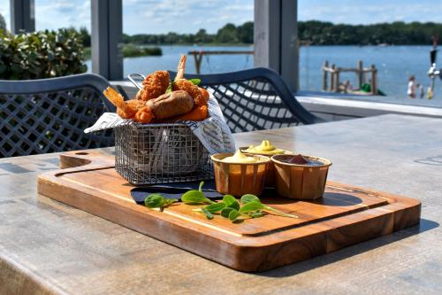 a cutting board with some food on a table at Strandparc Nulde in Putten