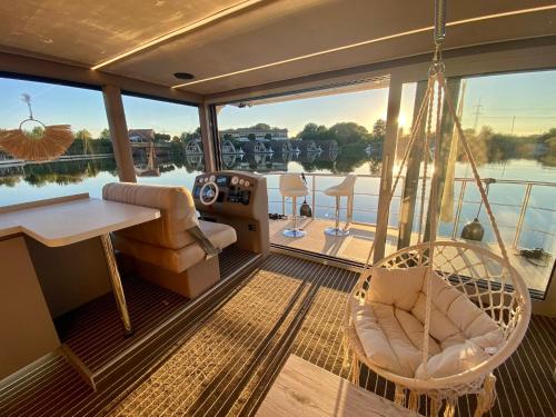 a porch on a boat with a swing at schwimmendes Luxboot in Parey