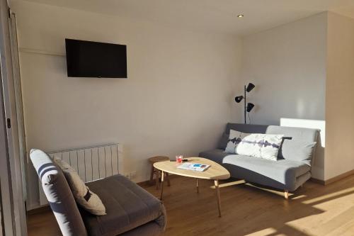 una sala de estar con un sofá y una mesa en Rare pearl with an incredible view of all Briançon, en Briançon