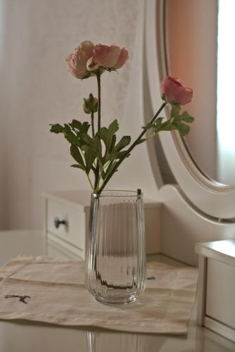 a vase with pink roses in it on a table at Haus Ronna in Schruns