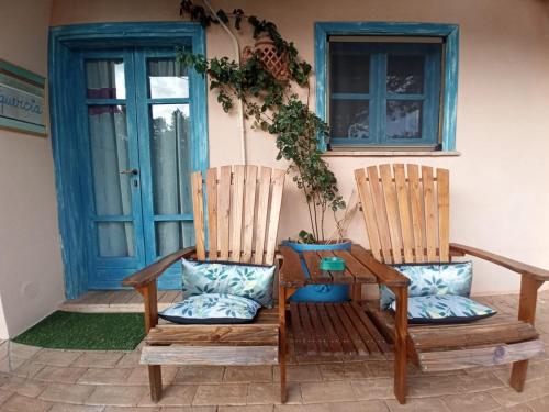 two chairs sitting on the porch of a house at Il Poggio di Teo in Manciano