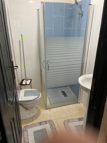a bathroom with a shower and a toilet and a sink at Unica Appartement meublé Fes in Fez