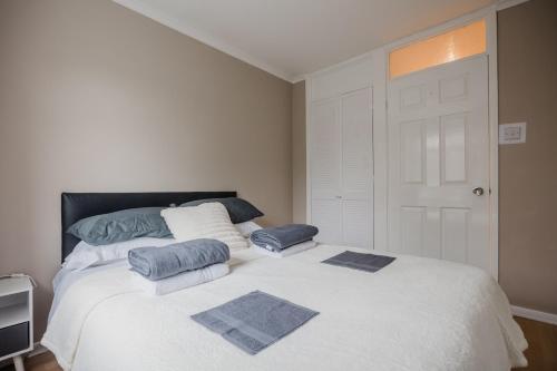a bedroom with a large bed with two pillows on it at Hullidays - Hymers Apartment in Hull
