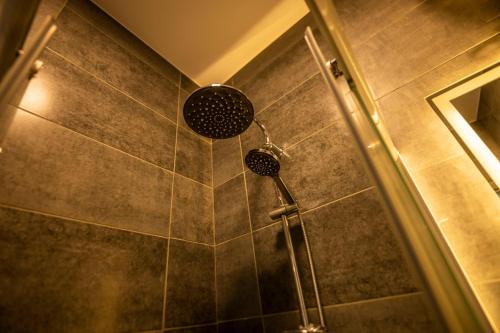 a shower with a shower head in a bathroom at El Gouna Elite Worldwide Sea & Garden Residences - Hurghada, Egypt in Hurghada
