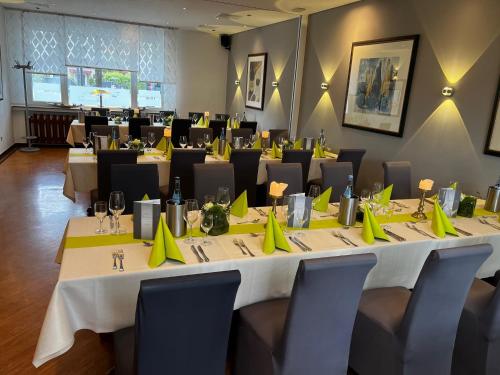 a conference room with tables and chairs with yellow napkins at Ziegenbruch´s Gastronomie in Spenge