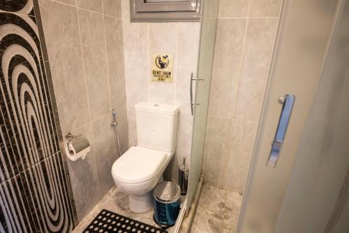 a small bathroom with a toilet and a shower at El Gouna Elite Worldwide Sea & Garden Residences - Hurghada, Egypt in Hurghada