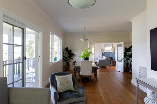 a living room with a table and chairs at Woodland Bay Retreat-Hot tub,Sauna and Bayview Retreat in Lymington