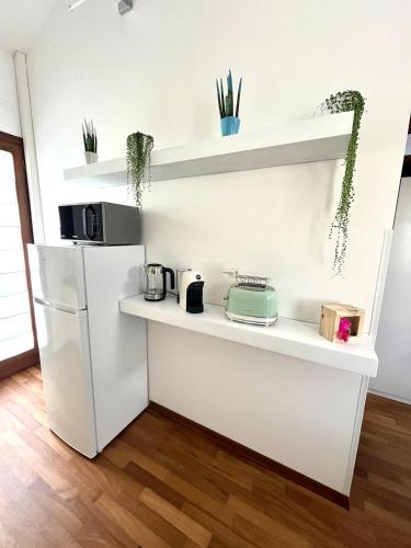 a kitchen with a white refrigerator and shelves at Casa dei Tempesta in Noale